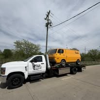 Tow truck transporting work van